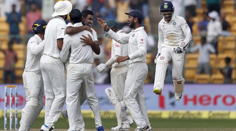 India's Ravichandran Ashwin, center without cap facing camera, celebrates with teammates the dismissal of Australia's Peter Handscomb during the fourth day of their second test cricket match in Bangalore, India, Tuesday, March 7, 2017. (AP Photo/Aijaz Rahi)