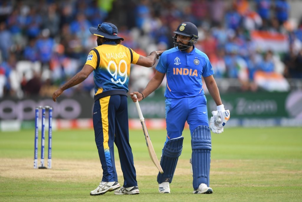Rohit Sharma is given a pat on the back by Lasith Malinga as he walks back to the pavilion © Getty Images