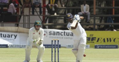 Asela Gunaratne tries to punch one down the ground © Associated Press