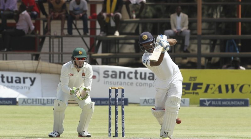 Asela Gunaratne tries to punch one down the ground © Associated Press