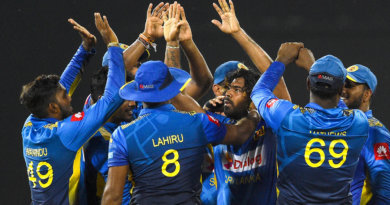 Lasith Malinga is swarmed by his team-mates © AFP