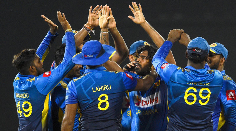 Lasith Malinga is swarmed by his team-mates © AFP