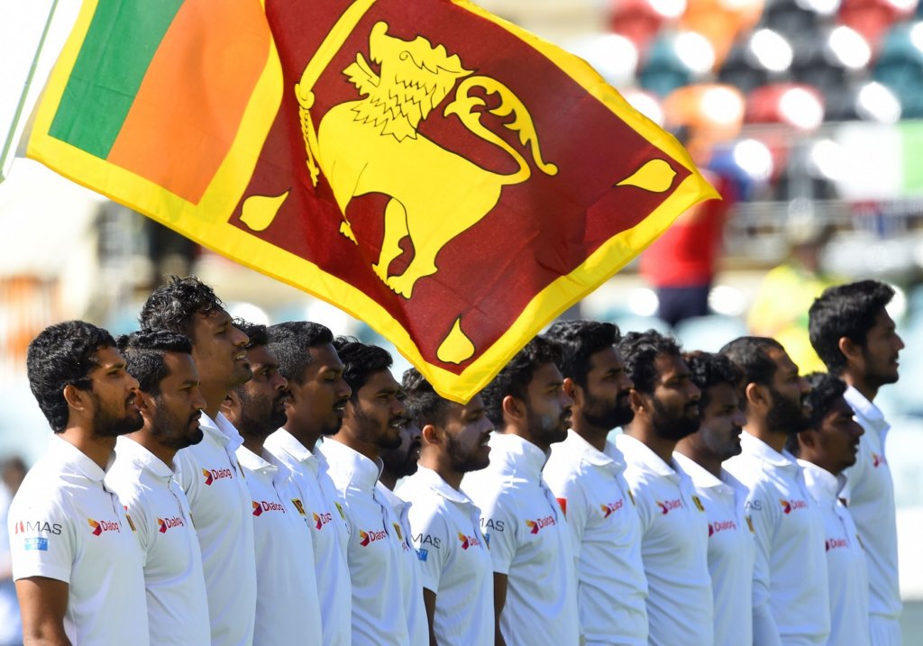 Sri Lanka's captain Dinesh Chandima (L) and teammates line up for the national anthem to celebrate the 71st Independence day before the start of day four of the second Test cricket match between Australia and Sri Lanka at the Manuka Oval Cricket Ground in Canberra on February 4, 2019. (Photo by ISHARA S. KODIKARA / AFP) / -- IMAGE RESTRICTED TO EDITORIAL USE - STRICTLY NO COMMERCIAL USE -- (Photo credit should read ISHARA S. KODIKARA/AFP/Getty Images)
