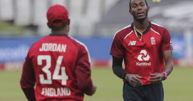 Jofra Archer receives the ball from Chris Jordan between bowls during the third T20 cricket match between South Africa and England in Cape Town, South Africa, Sunday, Nov. 29, 2020. (AP Photo/Halden Krog)