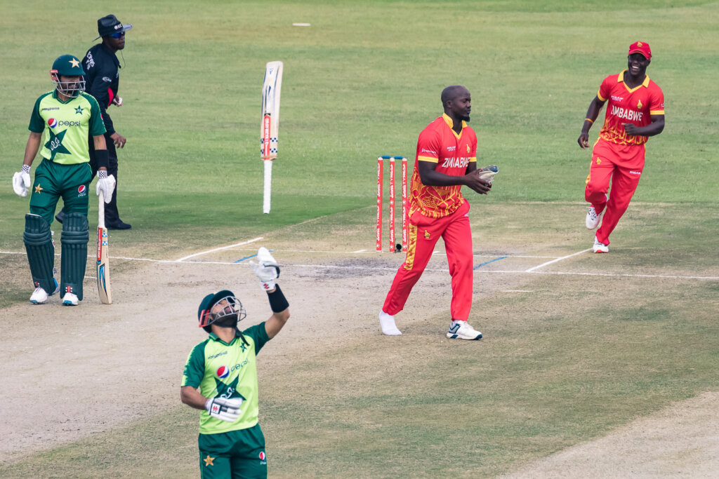 Zimbabwe's Luke Jongwe (2nd R) celebrates after the dismissal of Pakistan's Mohammad Rizwan (C) as he reacts during the second Twenty20 international cricket match between Zimbabwe and Pakistan at the Harare Sports Club in Harare on April 23, 2021. (Photo by Jekesai NJIKIZANA / AFP) (Photo by JEKESAI NJIKIZANA/AFP via Getty Images)
