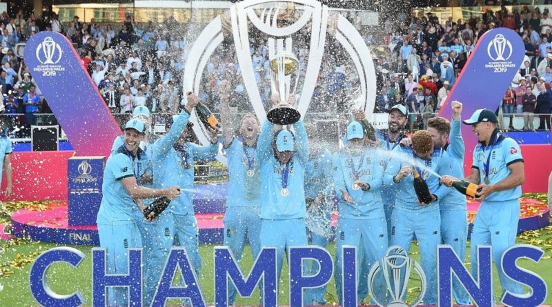 Eoin Morgan is sprayed with champagne as he holds the trophy aloft © Getty Images