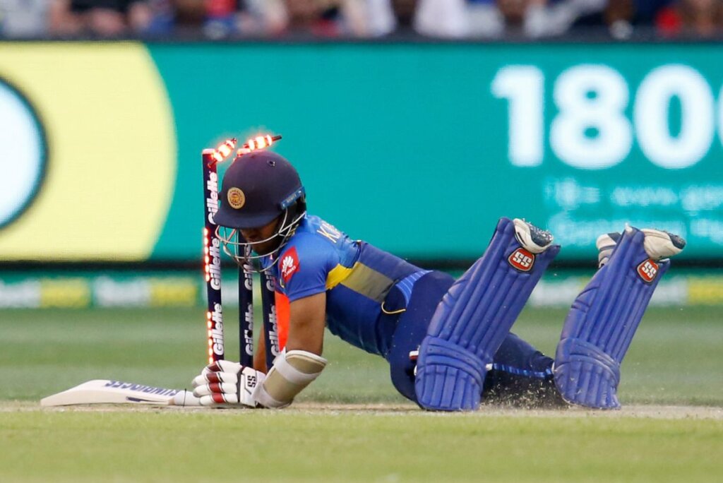 Kusal Mendis collides with the stumps as he looks to complete a run © Getty Images