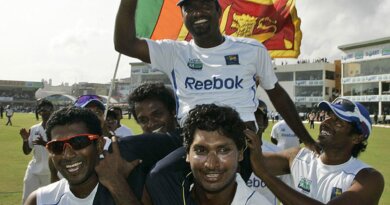 Muttiah Muralitharan is carried off the field by Kumar Sangakkara and Dammika Prasad © Associated Press