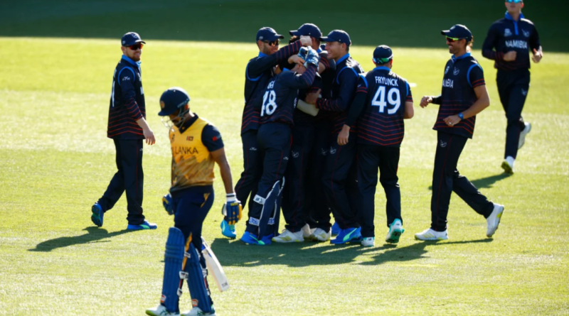 Ben Shikongo is mobbed by team-mates after claiming Danushka Gunathilaka for a golden duck •Oct 16, 2022•ICC/Getty Images
