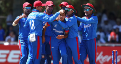 Fazal Haque is congratulated by his team-mates • Matthew Lewis-ICC/ICC via Getty Images