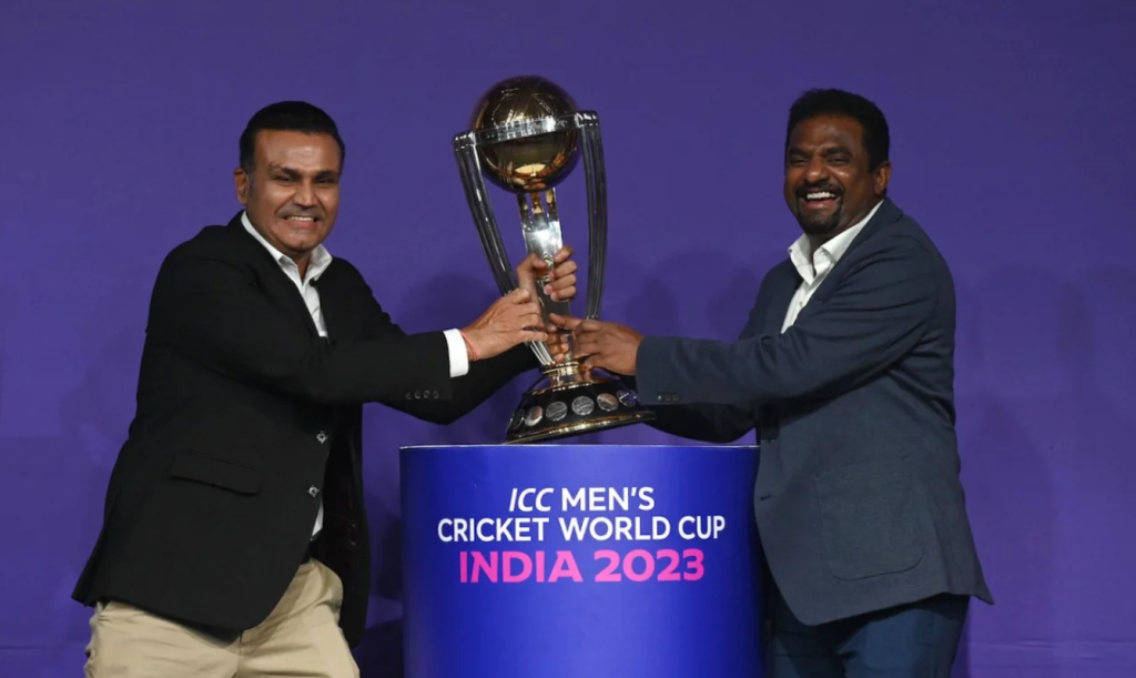 Virender Sehwag and Muthiah Muralidaran, both former ODI World Cup winners, mock tussle with the trophy at an event in Mumbai
