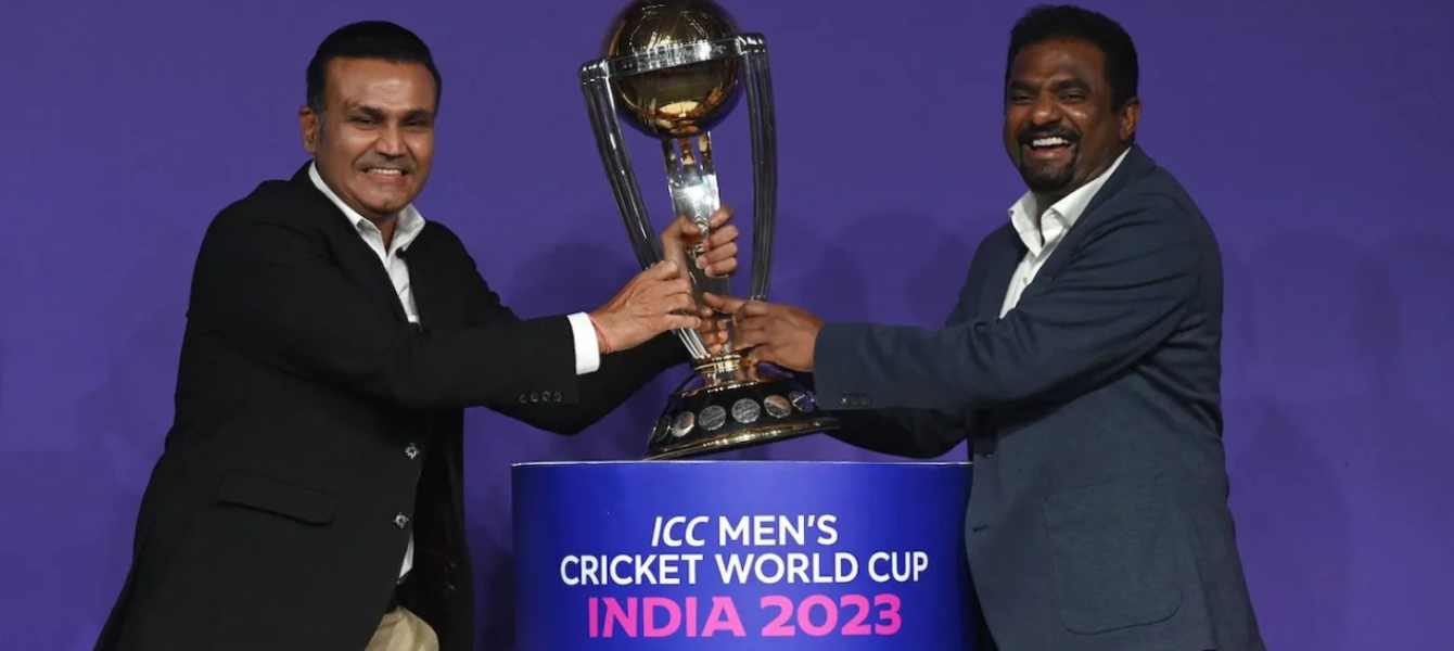 Virender Sehwag and Muthiah Muralidaran, both former ODI World Cup winners, mock tussle with the trophy at an event in Mumbai