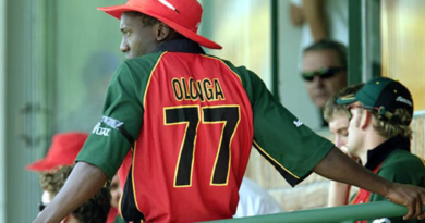 Henry Olonga wears a black armband in protest while in the players' enclosure•Feb 10, 2003•Reuters