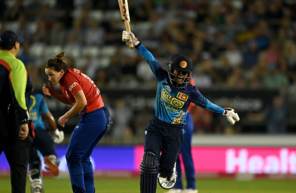 Harshitha Samarawickrama wheels past a cautious Kate Cross in celebration•Sep 06, 2023•Getty Images
