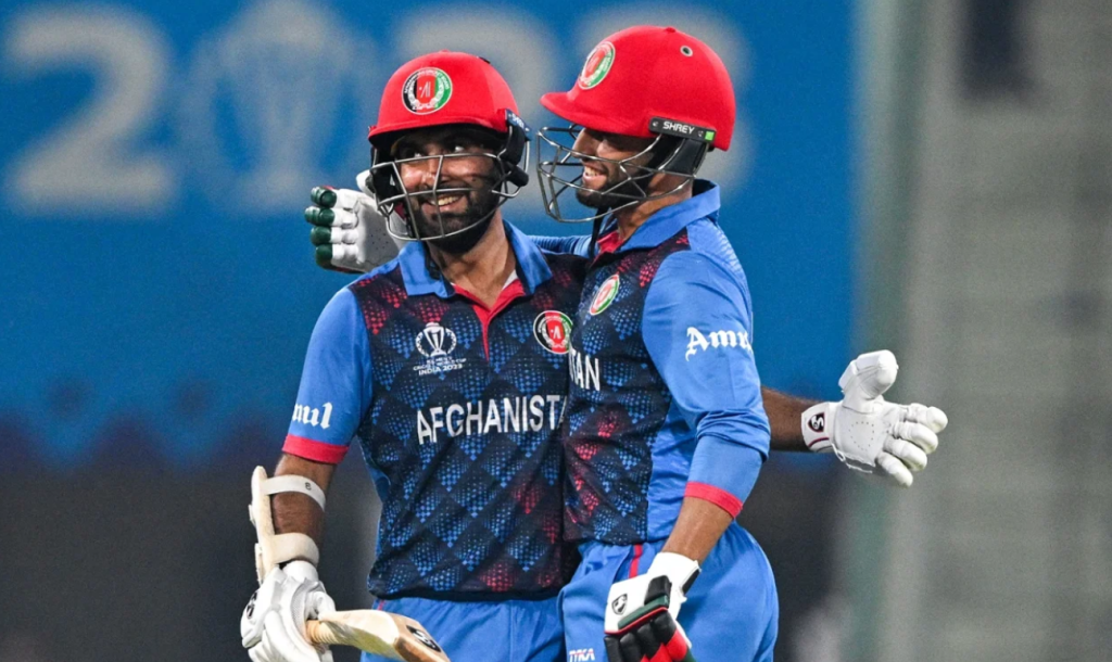 Hashmatullah Shahidi and Azmatullah Omarzai are smiles after Afghanistan's big win•Nov 03, 2023•AFP/Getty Images