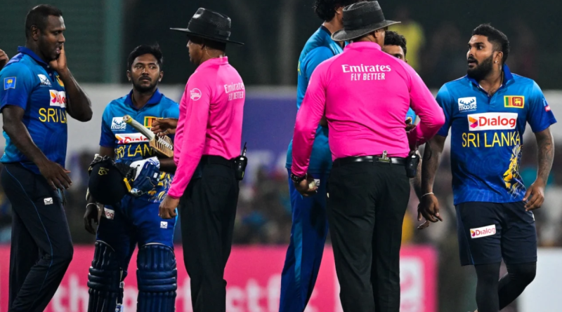 Wanindu Hasaranga and Angelo Mathews have a word with the umpire after the game•Feb 21, 2024•AFP/Getty Images